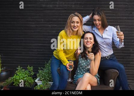 Group of partying girls with flutes with sparkling wine Stock Photo