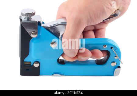 The furniture stapler in a man's hand isolated Stock Photo