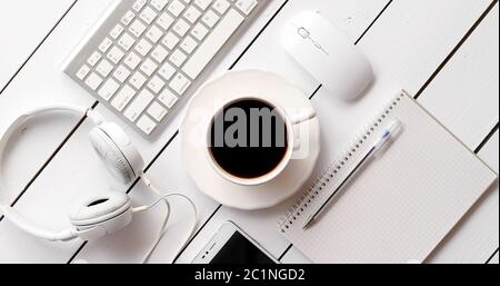 Devices and stationery near hot drink Stock Photo