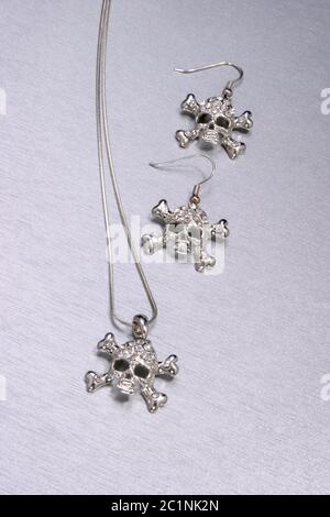 closeup of fashionable skull and crossbones necklace set Stock Photo
