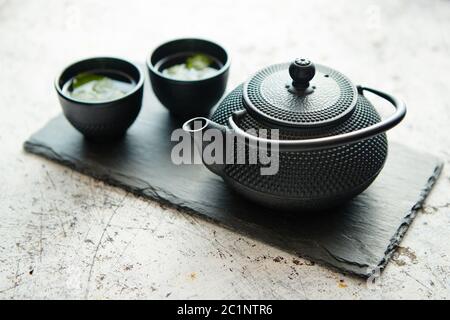 Traditional eastern metal teapot and iron cups Stock Photo