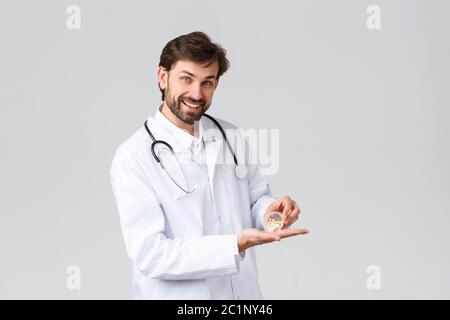 Handsome Doctor In Scrubs With Pills And Glass Of Water Handsome Doctor In Scrubs With Pills And Glass Of Water