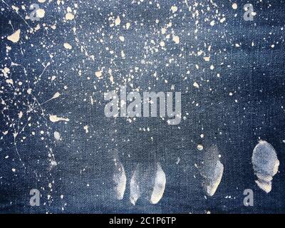 Texture of denim or blue jeans background. Drops of colorful paint on blue background denim, jeans. Stock Photo