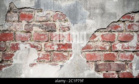 Old, plastered red brick wall with broken plaster as background or texture Stock Photo