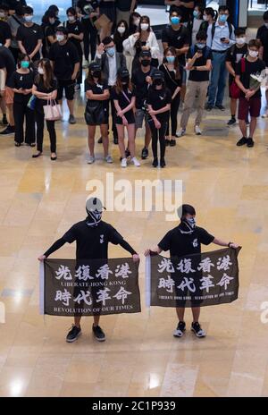 Hong Kong, Hong Kong, China. 15th June, 2020. Protesters hold anti government signs in Pacific Place Mall in Admiralty Hong Kong. They are there to commemorate the first democracy protester death on 15th June 2020. Marco Leung fell to his death from scaffolding outside the building 1 year ago. He became known as the raincoat man. Credit: Jayne Russell/ZUMA Wire/Alamy Live News Stock Photo