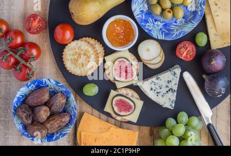 Cheese board with three cheeses, gouda with pimento, gouda with cumin seeds and roquefort blue chees Stock Photo