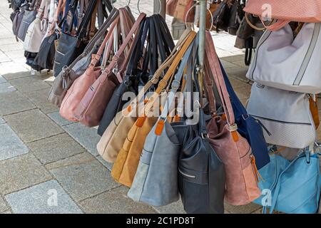 leather goods and handbags for sale at a flea market stall Stock