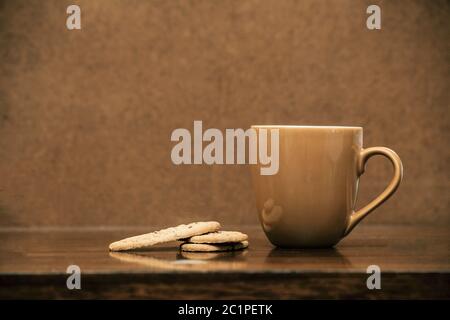 Cup of cappuccino coffee on dark table with cookies, colorful brown and clean Stock Photo