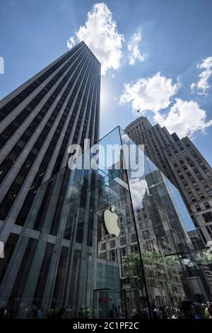 The iconic glass cube building of the Apple Store with round elevator and skyscapers seen from the interior on 5th Avenue in New York City Stock Photo