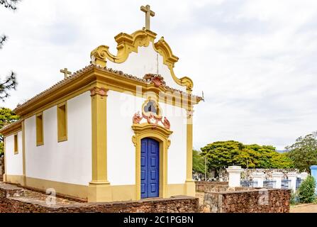 Facade of a historic church in colonial architecture with ancient cemetery behind Stock Photo