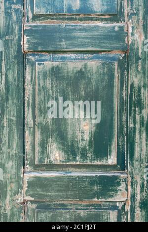 Detail of an old, weathered, green window shutter in portrait format Stock Photo