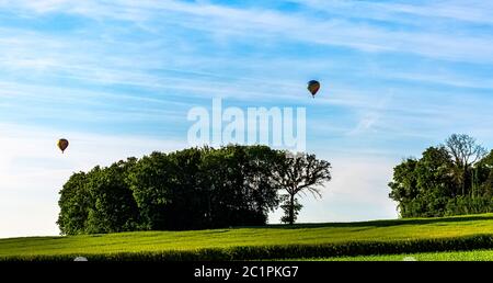 Hot air balloons over French fields - Dinan, France Stock Photo