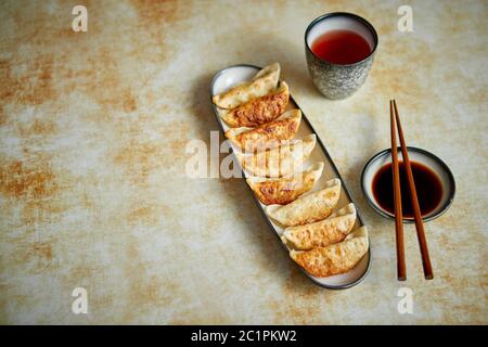 Orginal asian dumplings gyoza served in long plate Stock Photo