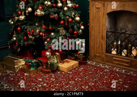 Christmas tree with red checkered bows and ribbons and festive mood near fire place. Stock Photo