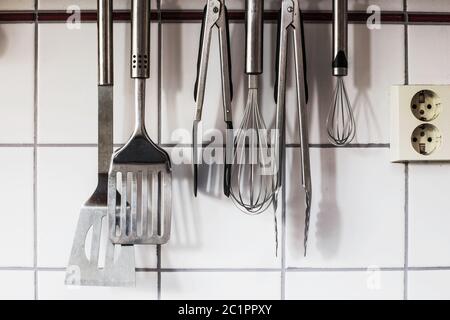 The kitchenware hanging on the wall in the kitchen Stock Photo