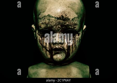 Creepy bloody doll in the dark Stock Photo