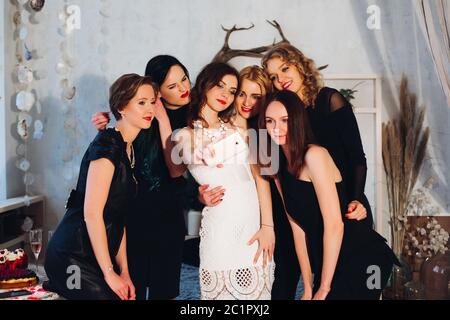 Beautiful bride and bridesmaids taking selfie together. Stock Photo