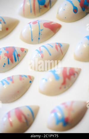 Different chocolate sweets on the white background. Stock Photo