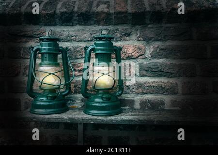 Old antique oil Lamp at Night on a Wooden Surface Stock Photo