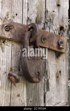 Old rusted lock on a rustic door with decorative natural weathered wood planks Stock Photo
