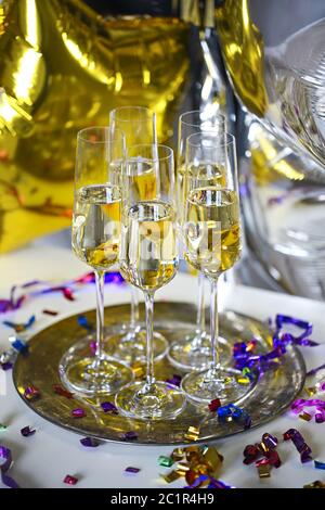 Close up of shiny glasses of champagne over party background Stock Photo