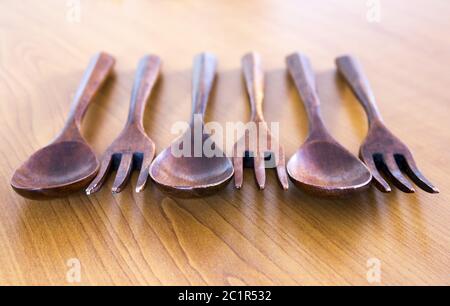 Wooden forks and spoons on wooden background Stock Photo