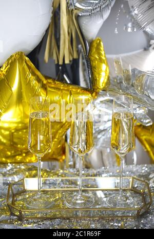 Close up of shiny glasses of champagne over party background Stock Photo