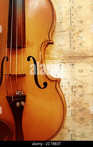 1937 old violin on the background of notes Stock Photo