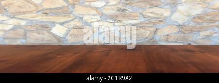 stone wall background and worn old oak table of wood. brown wooden table Stock Photo