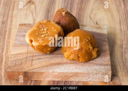 famous Indian food Khichdi is ready to serve sweet and delicious Jaggery,decorated with wooden background Stock Photo