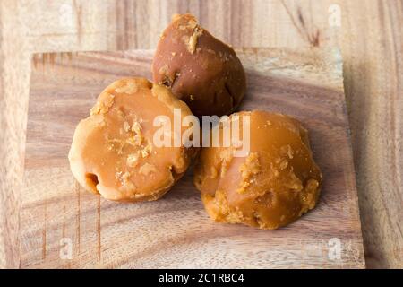 famous Indian food Khichdi is ready to serve sweet and delicious Jaggery,decorated with wooden background Stock Photo