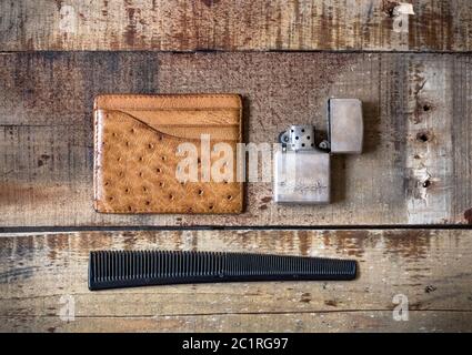 men accessories with lighter, comb and card wallet on wooden background Stock Photo