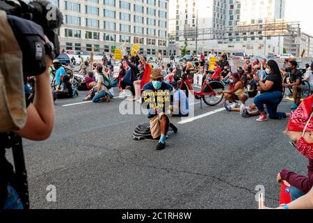 People kneel 8 minutes 46 seconds on Interstate 395 to remember George Floyd and protest police brutality, Washington, DC, United States Stock Photo