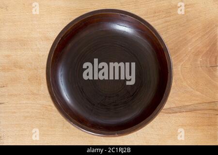 Wooden plate on wooden background Stock Photo