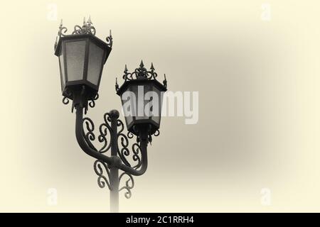 Vintage iron lantern on a city street on a foggy day Stock Photo