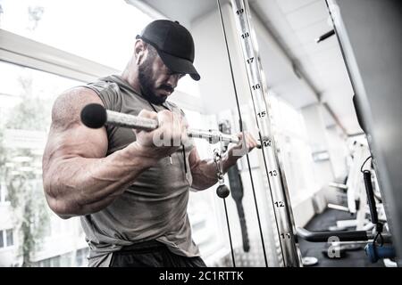 sport mental mind concentration of strong young bearded man training big muscle using fitness equipment during heavy workout exercise Stock Photo