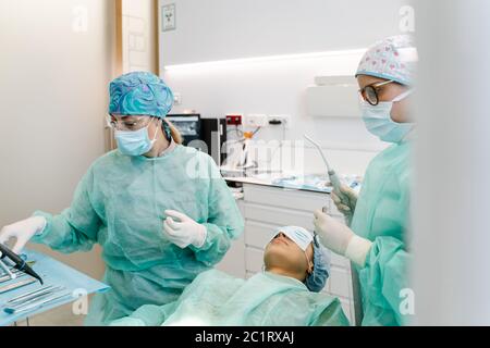 Doctor and hygienist prepare before operating on the patient in the dental clinic Stock Photo