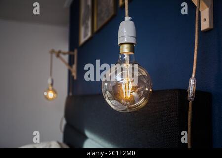 Decorative retro light bulbs against blue wall background, modern design Stock Photo