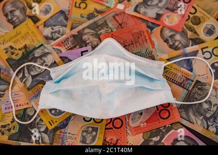 Brisbane, Australia. 16th June, 2020. In this photo illustration a face mask is displayed top of Australian dollar notes.Australian fear a huge financial crisis following coronavirus pandemic. (Photo by Flo Rols/Pacific Press) Credit: Pacific Press Agency/Alamy Live News Stock Photo