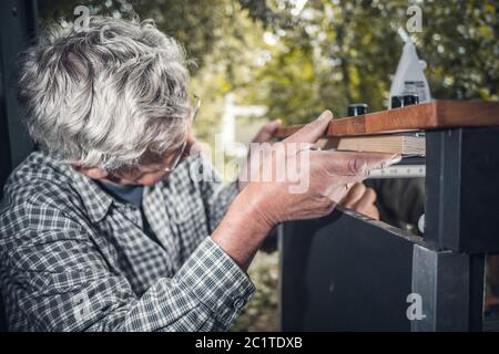 Senior man working with wood Stock Photo