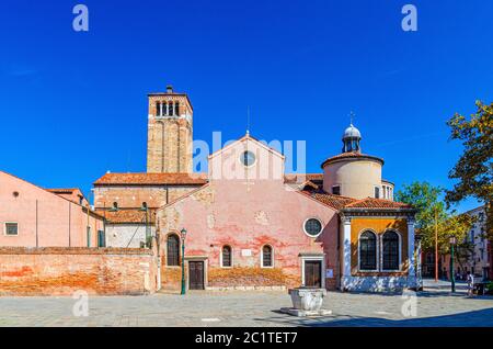 Chiesa di San Giacomo dall'Orio or San Giacomo Apostolo catholic church building with bell tower in Venice historical city centre, blue clear sky background in summer day, Veneto Region, Italy Stock Photo