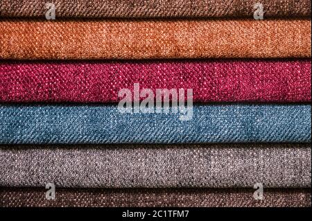Colorful and bright fabric samples of furniture and clothing upholstery. Close-up of a palette of textile abstract stripes of di Stock Photo