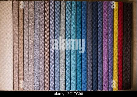 Colorful and bright fabric samples of furniture and clothing upholstery. Close-up of a palette of textile abstract stripes of di Stock Photo