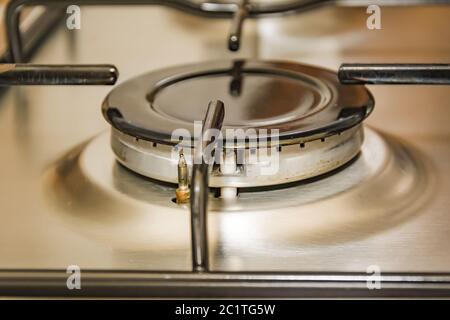 Close-up view of a stove burner in a metal kitchen Stock Photo