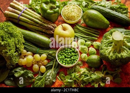 Fresh green vegetables and fruits assortment placed on a rusty metal Stock Photo