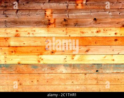 colorful old rustic wooden plank wall or floor with rich brown colored boards made of reused timber Stock Photo