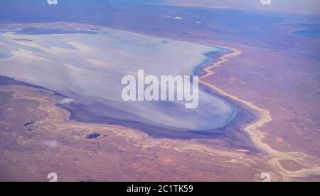 Aerial Panorama view to saline Barsa Kelmes lake and Ustyurt plateau at Karakalpakstan, Uzbekistan Stock Photo