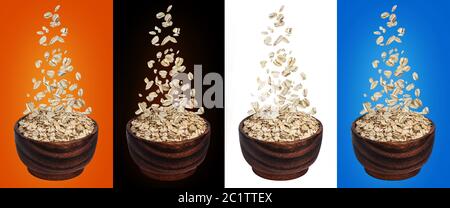 Oat flakes falling in bowl Stock Photo