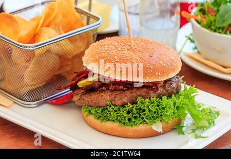 Tasty Burger with homemade Chips Stock Photo
