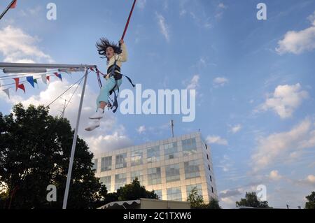 Little girl on bungee trampoline Stock Photo